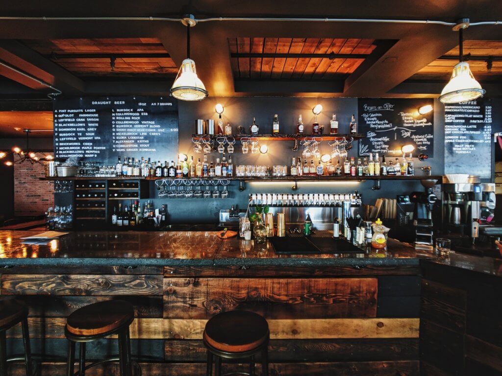 a bar with a black board and bottles on the wall | Restaurant Cleaning in Brisbane