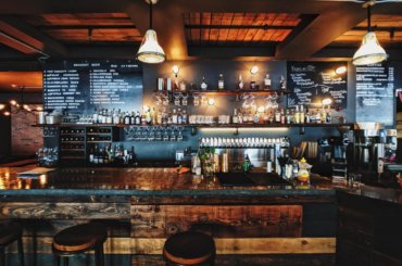 a bar with a black board and bottles on the wall | Restaurant Cleaning in Brisbane